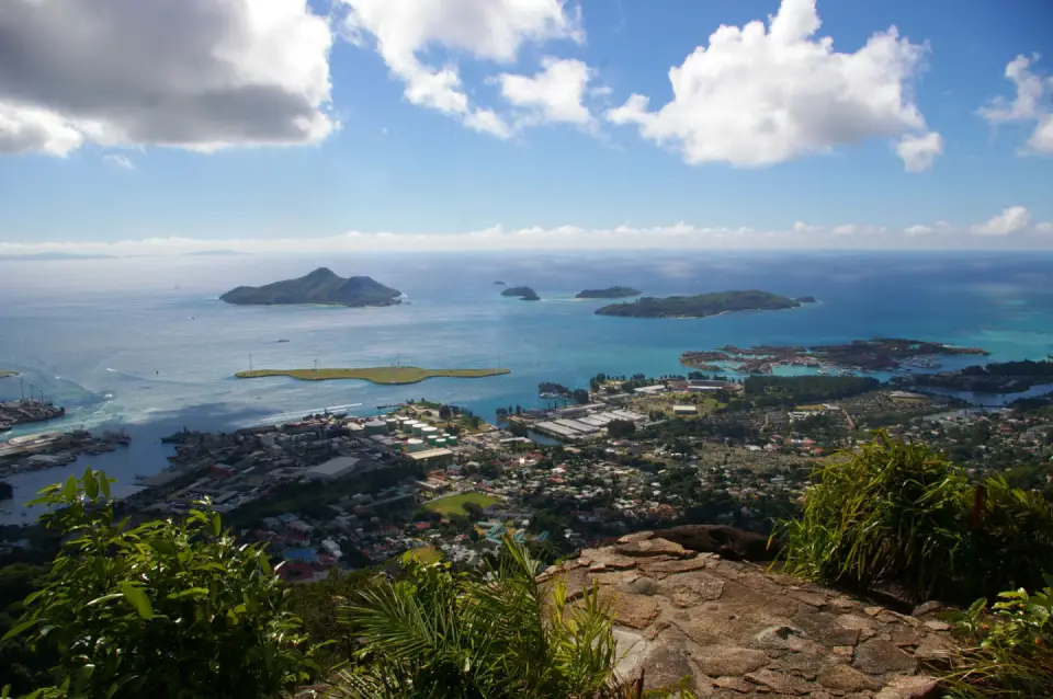 Panoramic view of Seychelles islands, turquoise ocean waters, green hills, and a beautiful tropical coastline.